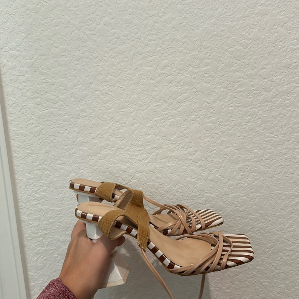 tan and white heels with small marks